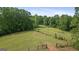 Expansive acreage offers open fields and wooded areas, creating a serene and private setting at 9511 High Point Rd, Villa Rica, GA 30180