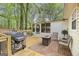 Back deck with seating area, grill, and screened in sun room, perfect for entertaining guests at 40 Green Leaf Cir, Hampton, GA 30228