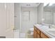 Bright bathroom with a window and a double sink vanity with wood cabinets at 40 Green Leaf Cir, Hampton, GA 30228
