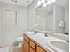 Bathroom featuring a double sink vanity, framed mirror, and a large window for natural light at 40 Green Leaf Cir, Hampton, GA 30228