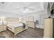 Spacious primary bedroom with trey ceiling, wood flooring, ceiling fan, and matching dressers at 40 Green Leaf Cir, Hampton, GA 30228
