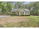 Charming single-story home with manicured lawn, covered parking, and lush landscaping at 40 Green Leaf Cir, Hampton, GA 30228