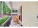 Inviting covered front porch with rocking chairs and views of the yard at 40 Green Leaf Cir, Hampton, GA 30228