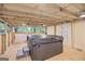 Enclosed back deck with a hot tub, wood flooring, and screened openings to allow in natural light at 40 Green Leaf Cir, Hampton, GA 30228