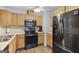 This is the kitchen featuring modern stainless-steel appliances and wood cabinets at 40 Green Leaf Cir, Hampton, GA 30228