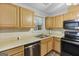 A modern kitchen features wood cabinets, stainless steel appliances, and a bright window over the sink at 40 Green Leaf Cir, Hampton, GA 30228