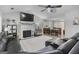 Open-concept living room with fireplace, large television, and dining area at 40 Green Leaf Cir, Hampton, GA 30228