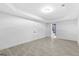 Spacious basement with tile floors, modern lighting and doors leading to bathroom at 1153 Dawn View Nw Ln, Atlanta, GA 30327