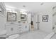 Modern bathroom featuring a double vanity, marble floors, and white cabinets at 1153 Dawn View Nw Ln, Atlanta, GA 30327