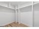 Walk-in closet with shelving units and hardwood floors at 1153 Dawn View Nw Ln, Atlanta, GA 30327