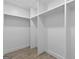 Empty walk-in closet with white shelving and tile floors at 1153 Dawn View Nw Ln, Atlanta, GA 30327