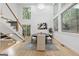 Bright dining room features high ceilings, large windows, wood floors, and modern staircase at 1153 Dawn View Nw Ln, Atlanta, GA 30327