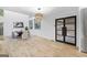 Open-concept dining room with modern light fixture, hardwood floors, and stainless steel refrigerator at 1153 Dawn View Nw Ln, Atlanta, GA 30327