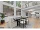 Open-concept dining area with modern chandelier, large windows, and hardwood floors at 1153 Dawn View Nw Ln, Atlanta, GA 30327