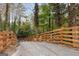 Long driveway with a wooden fence leads to the modern home, enhancing privacy and curb appeal at 1153 Dawn View Nw Ln, Atlanta, GA 30327