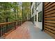 Modern home exterior with wooden deck featuring ample outdoor space with a manicured lawn and greenery at 1153 Dawn View Nw Ln, Atlanta, GA 30327