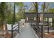 Stylish modern home featuring a gated entry bridge with lights, and natural landscaping at 1153 Dawn View Nw Ln, Atlanta, GA 30327