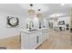 Kitchen island featuring marble countertop, modern faucet, and views of the dining and living areas at 1153 Dawn View Nw Ln, Atlanta, GA 30327