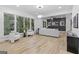 Bright living area with large windows overlooking the trees, modern furnishings, hardwood floors, and a dark accent wall at 1153 Dawn View Nw Ln, Atlanta, GA 30327