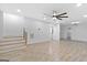 Spacious recreation room with ceiling fan, access to the staircase, and wood look tile at 1153 Dawn View Nw Ln, Atlanta, GA 30327