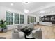Bright and airy living room with hardwood floors, large windows with wooded views, and unique gray and gold seating at 1153 Dawn View Nw Ln, Atlanta, GA 30327