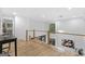 Bright loft area featuring wood floors, modern railings, and a stylish light fixture at 1153 Dawn View Nw Ln, Atlanta, GA 30327