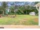 Large backyard featuring mature trees, playground, shed, and a fire pit at 308 Dylan Way, Mcdonough, GA 30252