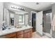 Bathroom featuring a dual sink vanity and a walk in shower at 308 Dylan Way, Mcdonough, GA 30252