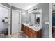 Bathroom with a dual sink vanity, large mirror, and walk in closet at 308 Dylan Way, Mcdonough, GA 30252