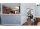 Open kitchen area with stainless appliances and bar height counter to adjacent room at 308 Dylan Way, Mcdonough, GA 30252