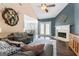 Open-concept living room with fireplace, hardwood floors, and view into the breakfast nook at 308 Dylan Way, Mcdonough, GA 30252