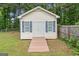 Shed with white siding, a gray roof, and a ramp at 308 Dylan Way, Mcdonough, GA 30252