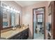 Cozy bathroom boasting a copper sink, dark wood vanity, framed mirror and adjoining toilet area at 6537 Walker Rd, Riverdale, GA 30296