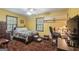 Comfortable bedroom featuring a queen-sized bed, desk area, plush carpet, and natural light at 6537 Walker Rd, Riverdale, GA 30296