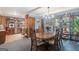 Inviting dining room featuring wood table, chandelier, and built-in shelving filled with decorative collectibles at 6537 Walker Rd, Riverdale, GA 30296