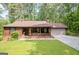 Charming single-story home featuring a welcoming front porch and well-maintained lawn at 6537 Walker Rd, Riverdale, GA 30296