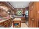 Rustic kitchen featuring brick details, stainless steel appliances, wood countertops, and patterned tile flooring at 6537 Walker Rd, Riverdale, GA 30296