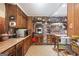 Charming kitchen boasting brick accents, wooden cabinetry, stainless steel appliances, and decorative tile flooring at 6537 Walker Rd, Riverdale, GA 30296
