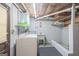Bright laundry room featuring functional layout with brick walls and overhead lighting at 6537 Walker Rd, Riverdale, GA 30296
