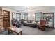 This living room has a fireplace, built-in shelving, and large windows at 6537 Walker Rd, Riverdale, GA 30296