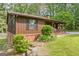 The side of this charming home features updated landscaping and a brick foundation at 6537 Walker Rd, Riverdale, GA 30296
