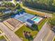 An aerial view of tennis courts and a community pool, enhanced by sidewalks and manicured lawns at 440 Homeplace Dr, Stockbridge, GA 30281