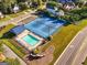 An aerial view of a community pool and tennis courts surrounded by well-maintained landscaping and neighborhood homes at 440 Homeplace Dr, Stockbridge, GA 30281