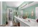 Bright bathroom with a double sink vanity, large mirror and separate shower and toilet area at 440 Homeplace Dr, Stockbridge, GA 30281