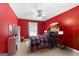 Bright red bedroom featuring a skateboard decoration, ceiling fan and neutral carpet at 440 Homeplace Dr, Stockbridge, GA 30281