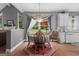 Cozy dining area adjacent to kitchen, featuring hardwood floors and a chandelier over the dining table at 440 Homeplace Dr, Stockbridge, GA 30281