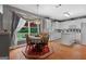 Cozy dining area adjacent to kitchen, featuring hardwood floors and a chandelier over the dining table at 440 Homeplace Dr, Stockbridge, GA 30281