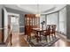 Charming dining room with hardwood floors, dining table, and view into the kitchen at 440 Homeplace Dr, Stockbridge, GA 30281