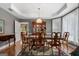 Formal dining room featuring tray ceilings, wooden table set, and china cabinet at 440 Homeplace Dr, Stockbridge, GA 30281