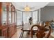 Elegant dining room with china cabinet, tray ceiling, and bay window at 440 Homeplace Dr, Stockbridge, GA 30281